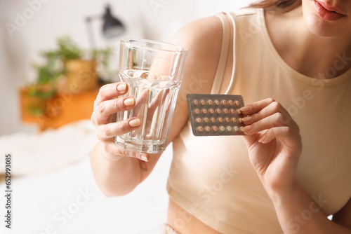 Young woman with glass of w...