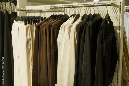 Modern plain clothes - trousers and sweaters, on a hanger in the store