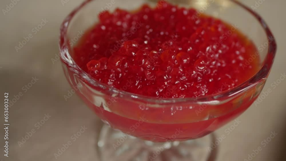 Red caviar in a crystal saucer on the table Red caviar in a crystal saucer on the table