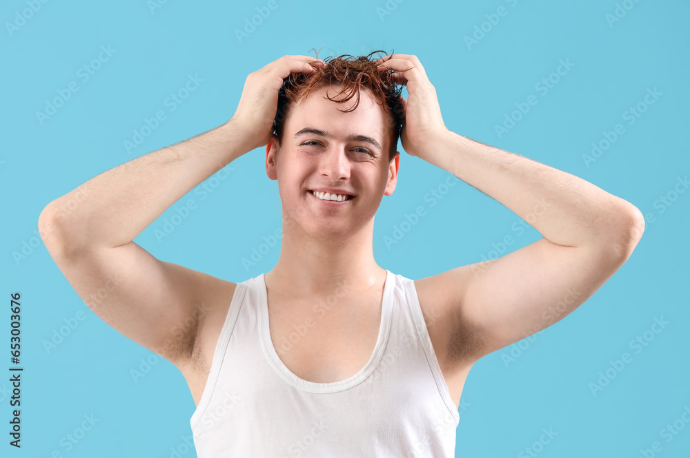 Young man with wet hair on light blue background Young man with wet hair on light blue background