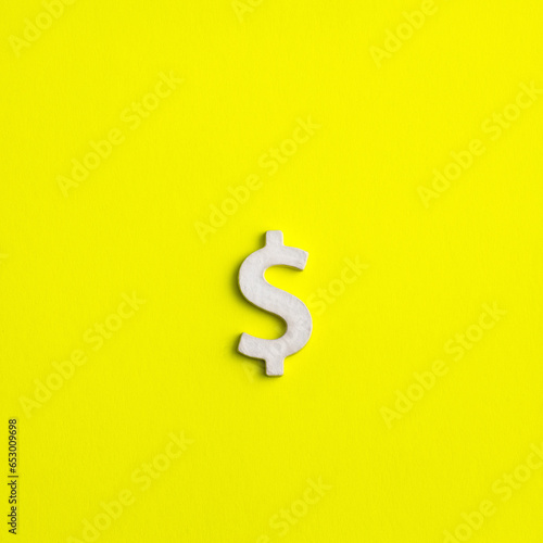 Fototapeta Naklejka Na Ścianę i Meble -  White dollar sign on yellow background - Business concept