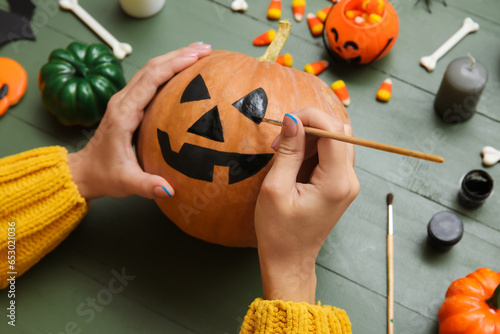Woman painting Halloween pu...