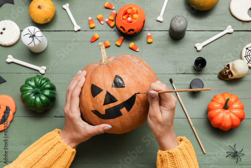 Woman painting Halloween pu...