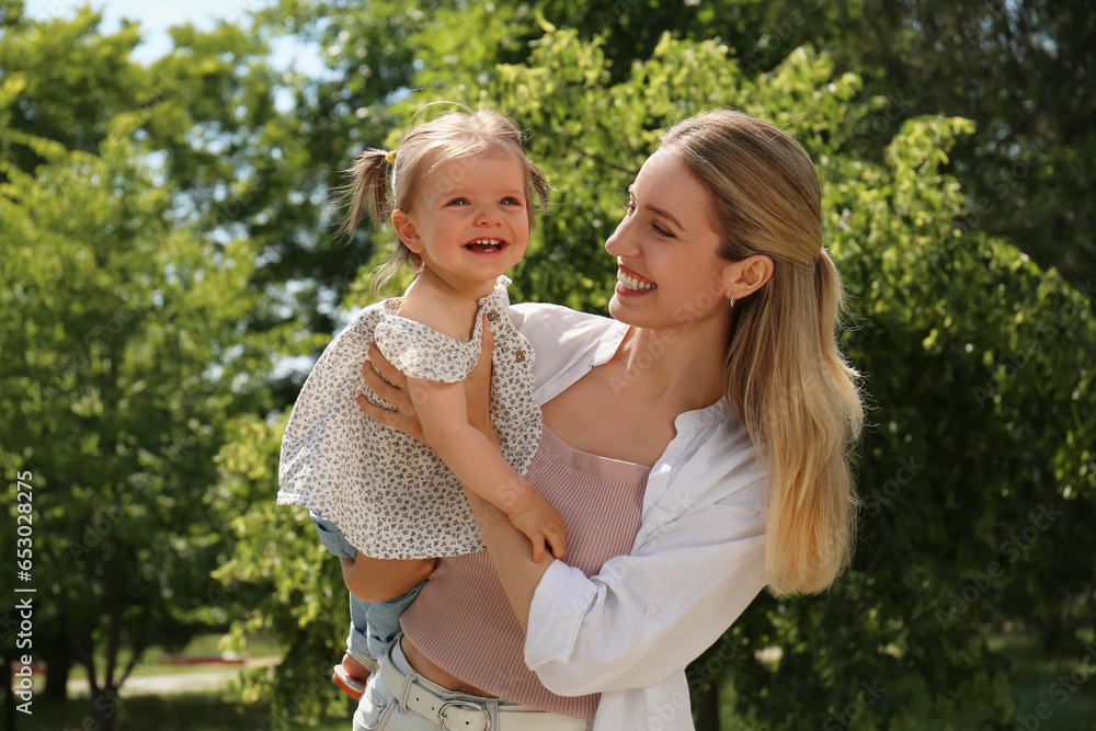 Happy mother with her daughter having fun in park Happy mother with her daughter having fun in park