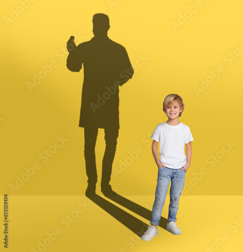 Dream about future occupation. Smiling boy and silhouette of singer on yellow background