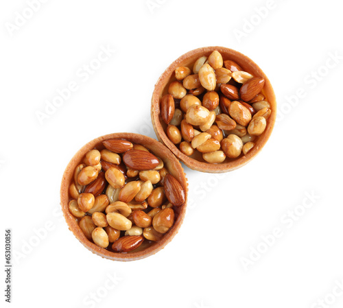 Tartlets with caramelized nuts isolated on white, top view. Tasty dessert