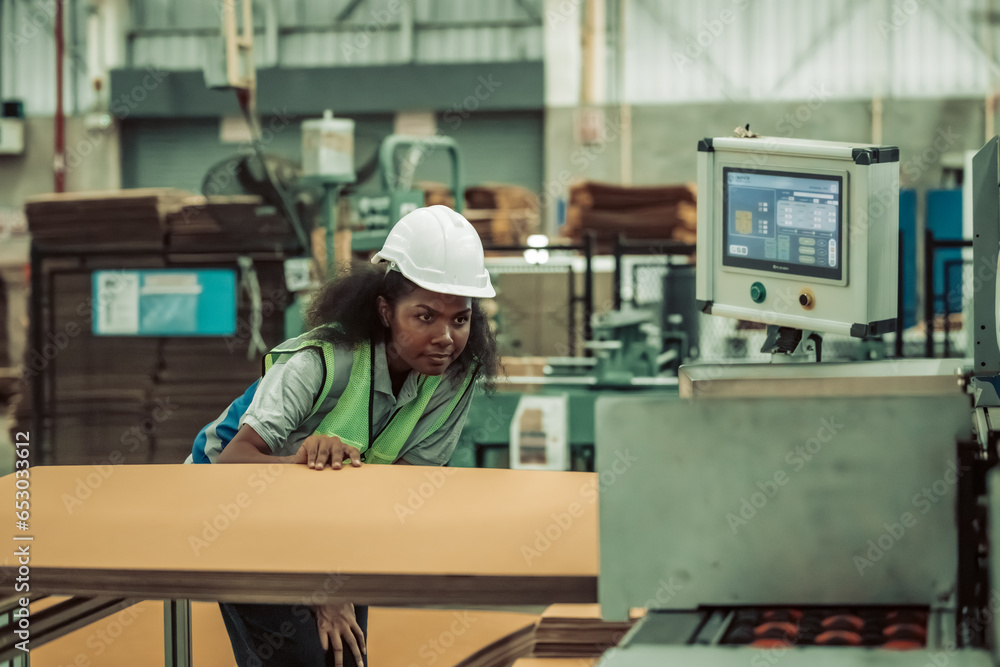 The tech prepare cardboard sheet with precision before automating production in the paper factory. The tech prepare cardboard sheet with precision before automating production in the paper factory.