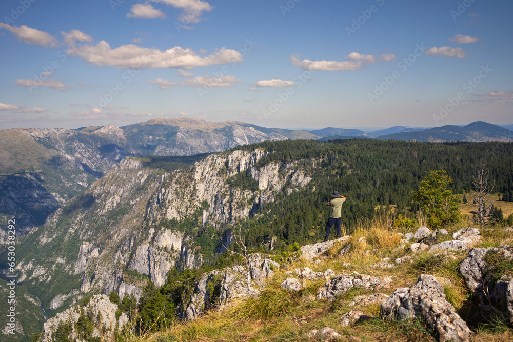 Hiker in the mountains look to the distance. Tara Canyon in Montenegro . 