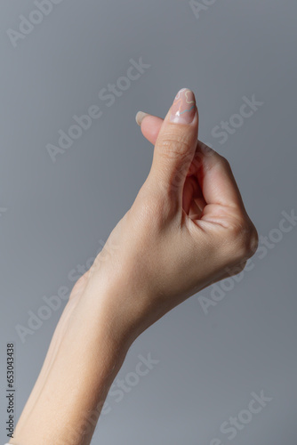 Female Hand Making the Heart Sign Close up © Adalberto