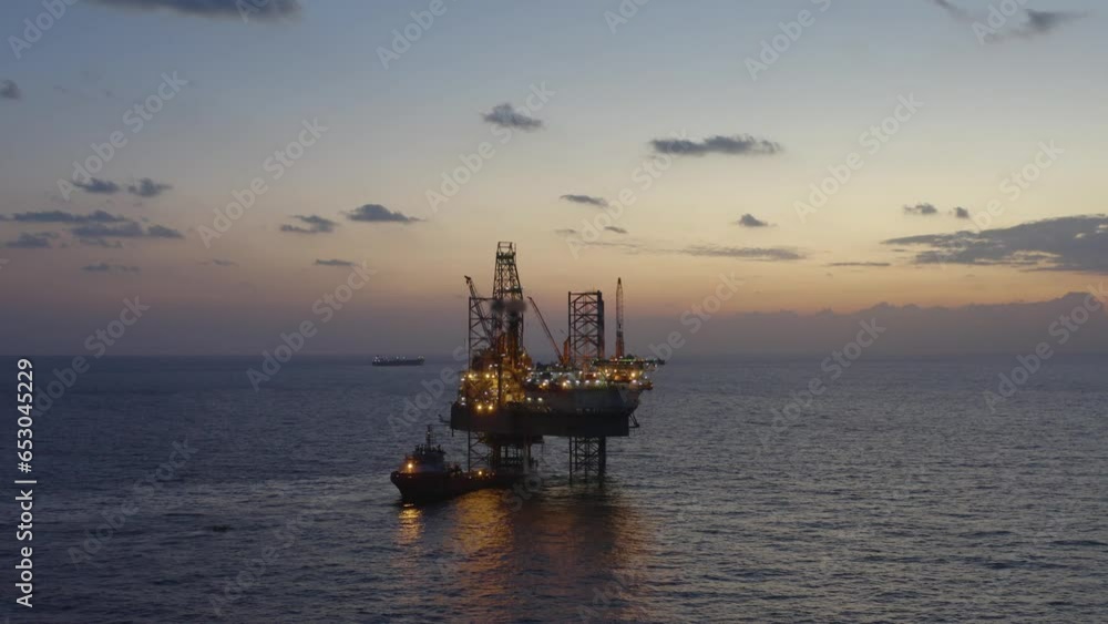 Aerial view of offshore jack up drilling rig during early night time - oil and gas industry
Aerial view of offshore jack up drilling rig during early night time - oil and gas industry