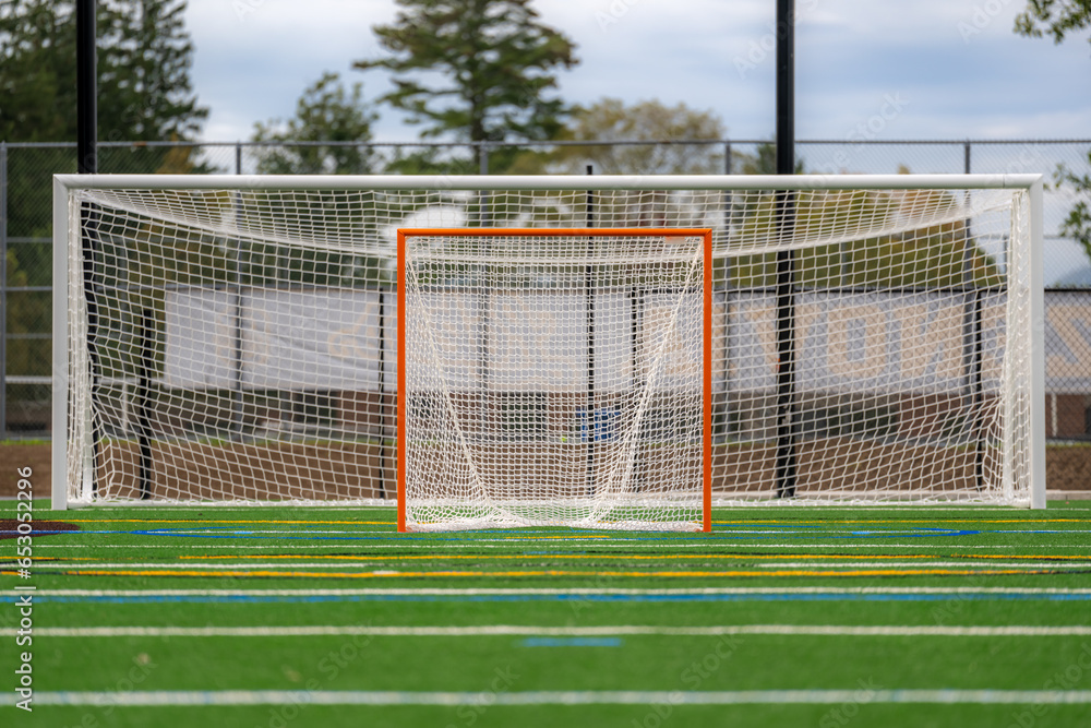 Fototapeta premium Photo of a lacrosse goal on a empty green synthetic turf field. 