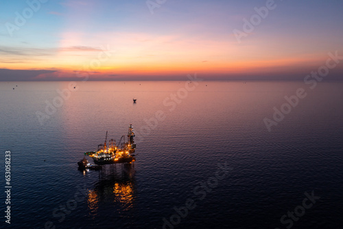 Aerial view of jack up drilling rig in the middle of the ocean during night time