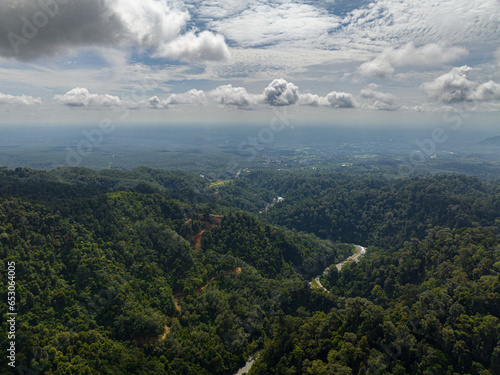 Aerial drone of mountains covered rainforest  trees and blue sky with clouds. Sumatra  Indonesia.