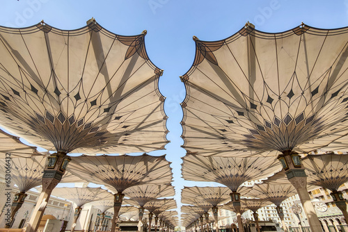 Courtyard of the Al Haram or Al-Masjid an-Nabawi mosque in Medina Saudi Arabia on a sunny day. It was the second mosque built by Muhammad in Medina and is now one of the largest mosques in the world. photo