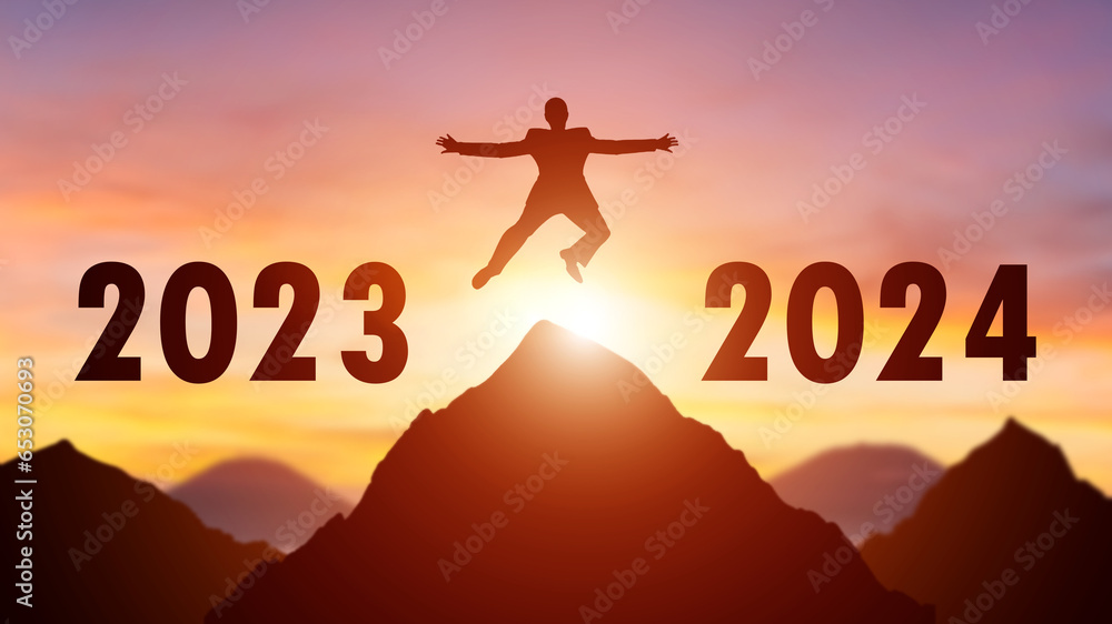 Silhouette of a person leaping from 2023 to 2024 on the top of the mountain background. Happy New Year and Christmas day concept. Silhouette of a person leaping from 2023 to 2024 on the top of the mountain background. Happy New Year and Christmas day concept.