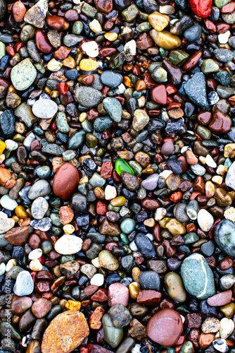 Sea glass among pebbles on the beach background