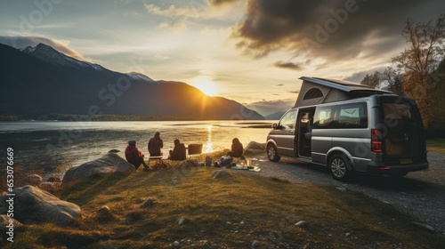 family camping car Go on holiday in a campervan, parked next to the river, with the mountains behind the sunset.