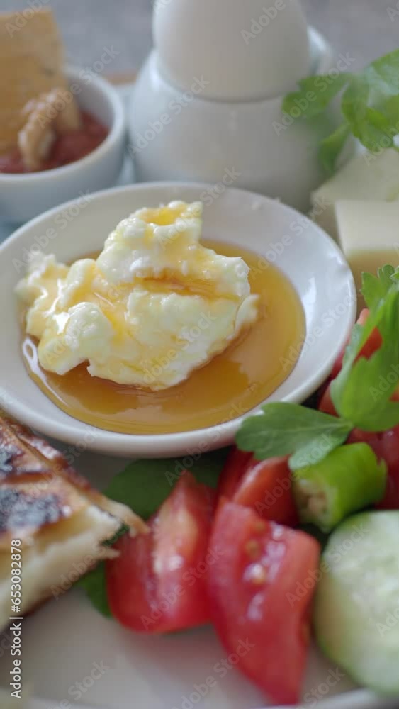 butter cream and honey in a bowl on table . butter cream and honey in a bowl on table .