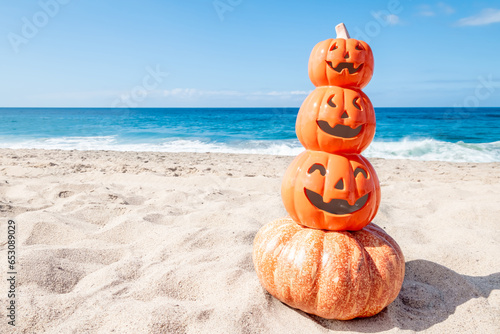 Happy Halloween background with pumpkins on the beach