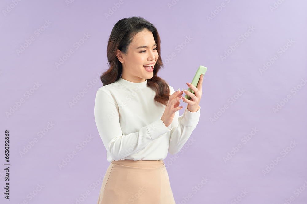 Cheerful asian young woman using smartphone. Cheerful asian young woman using smartphone.