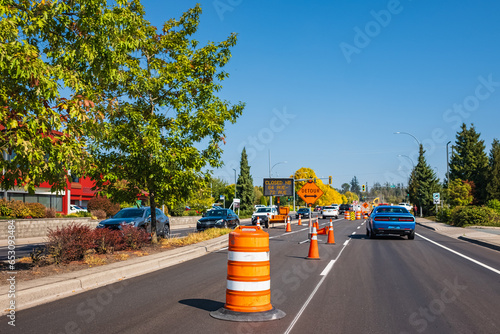 Φωτογραφία Traffic sign with flags reading Utility Work Ahead with traffic cones on road