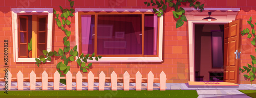House facade with red brick wall, open door and windows. Vector cartoon illustration of home entrance with welcome mat on porch, nice white fence and green lawn outdoors, residential building interior