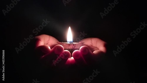 Diya Lamp for Diwali festival in the hand night background