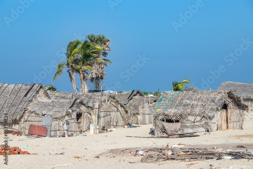 Photography Thatched coconut leaf hut and fishing net of Indian fisherman on sea shore Rameshwaram Dhanushkodi beach, Tamil Nadu, India