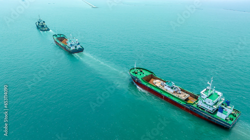 Tug Boat drag 3 cargo ship in the ocean. 3 Ship running straight line.