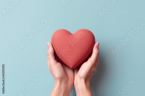 Man hand holding a red heart shape isolated on plain background