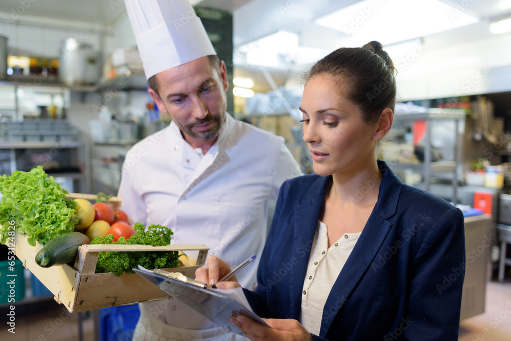 © auremar - restaurant manager talking to male chef in commercial kitchen © auremar - restaurant manager talking to male chef in commercial kitchen