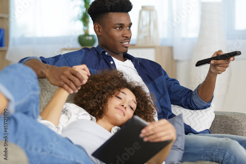 affectionate couple relaxing together on a sofa photo