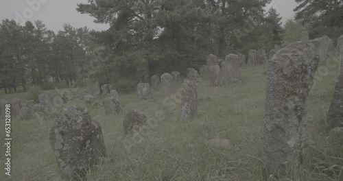 Old ancient Jewish cemetery in summer spring day. Druya, Belarus. green grass and many ancient stones. Headstone Headstones Tombstones jewish grave, clog2, clog, canon c70 c log 2. photo