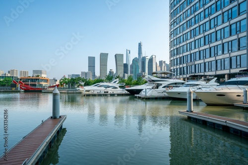 financial district buildings of shanghai in sunny day, and the yacht docked at the dock