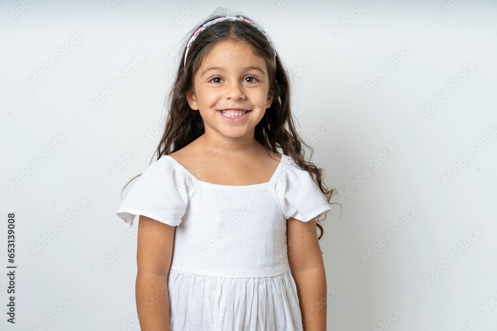 Close up photo of beautiful kid girl wearing white dress toothy smiling Close up photo of beautiful kid girl wearing white dress toothy smiling