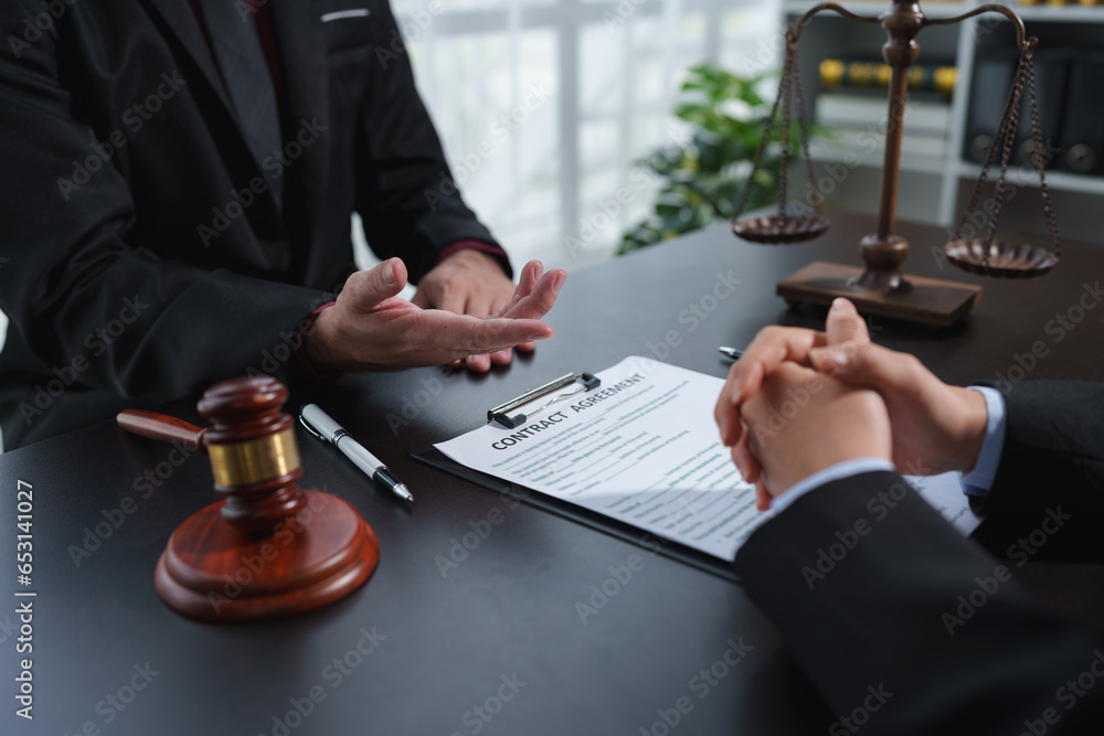 A lawyer or legal advisor is reading the statute of limitations. Clarifying details of legal contracts before signing. Consultation between lawyers and business clients. Legal services company.