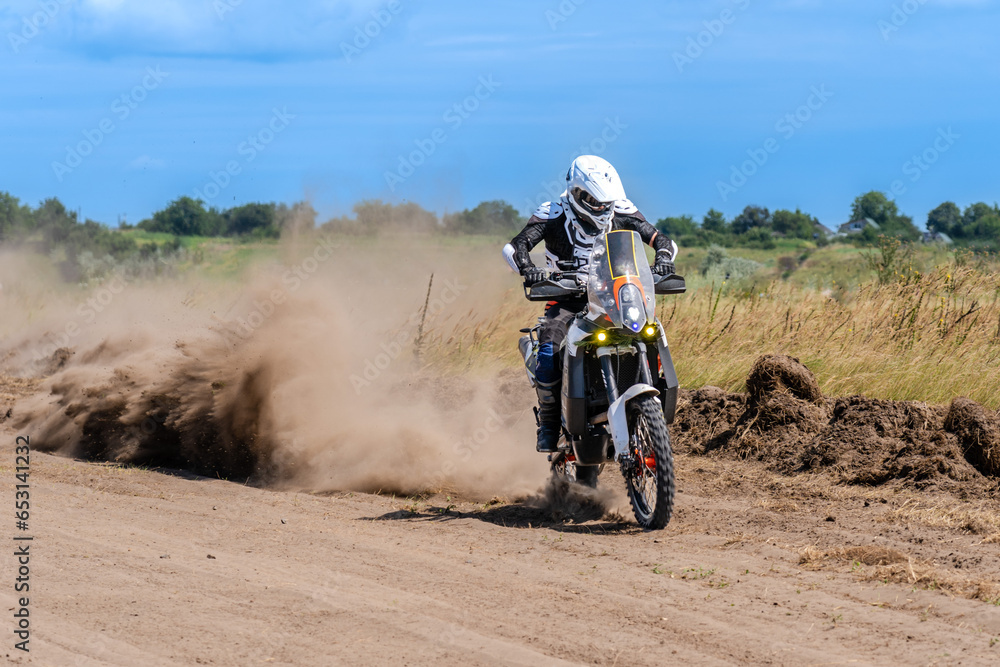 Motocross rider riding on extreme dust track Motocross rider riding on extreme dust track
