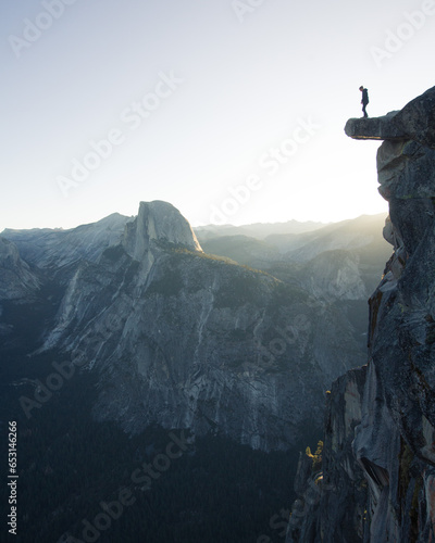 Man standing on rock overlooking yosemite national park