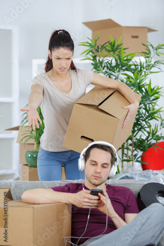 young woman threatening husband at home photo