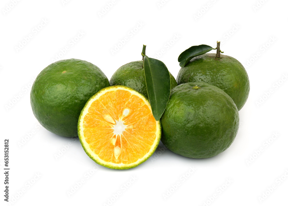 Sliced and whole green oranges isolated on white background