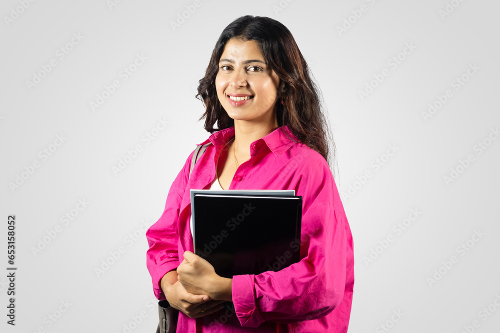 Young and Beautiful Asian Nepalese Student Abroad Study Giving gestures with notebook in hand Young and Beautiful Asian Nepalese Student Abroad Study Giving gestures with notebook in hand