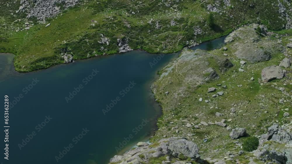 Water surface of mountain lake in summer season in Valmalenco of Valtellina in northern Italy. Aerial drone top down view Water surface of mountain lake in summer season in Valmalenco of Valtellina in northern Italy. Aerial drone top down view
