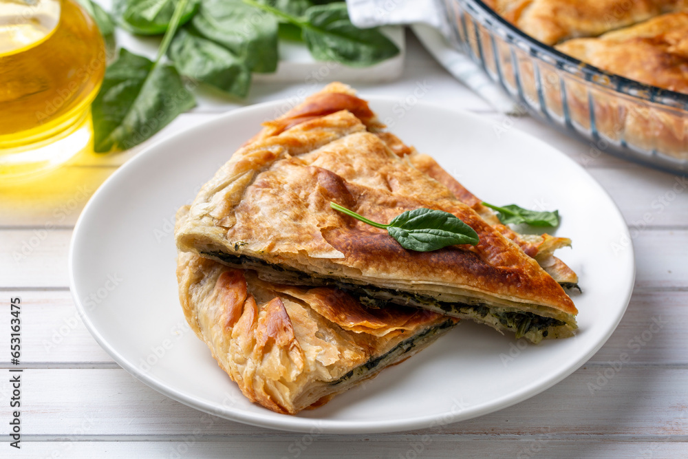 Spanakopita, greek phyllo pastry pie with spinach and feta cheese filling. Delicious handmade pies. Turkish name; el acmasi borek Spanakopita, greek phyllo pastry pie with spinach and feta cheese filling. Delicious handmade pies. Turkish name; el acmasi borek