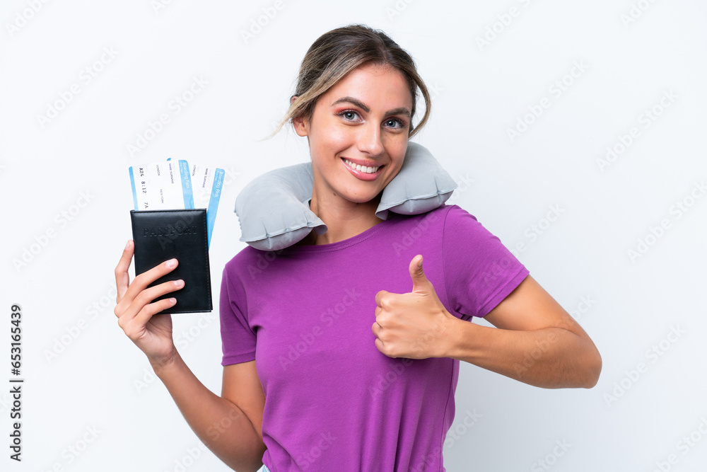 Young pretty Uruguayan woman with Inflatable Travel Pillow isolated on white background giving a thumbs up gesture Young pretty Uruguayan woman with Inflatable Travel Pillow isolated on white background giving a thumbs up gesture