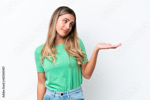Young Uruguayan woman isolated on white background holding copyspace with doubts