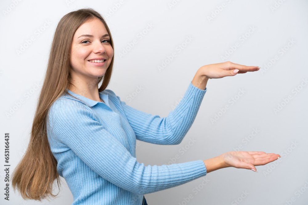 Young Lithuanian woman isolated on white background holding copyspace to insert an ad Young Lithuanian woman isolated on white background holding copyspace to insert an ad