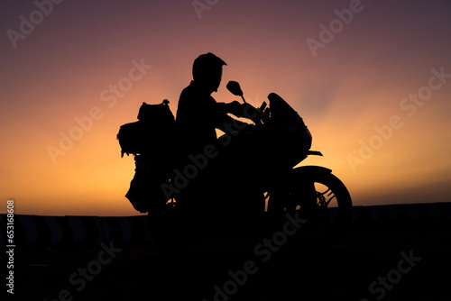 biker men and classic motorcycle at sunset