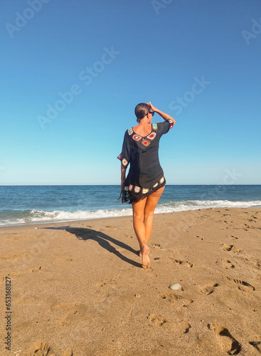 girl walking on the beach in cabo de gata, Almería