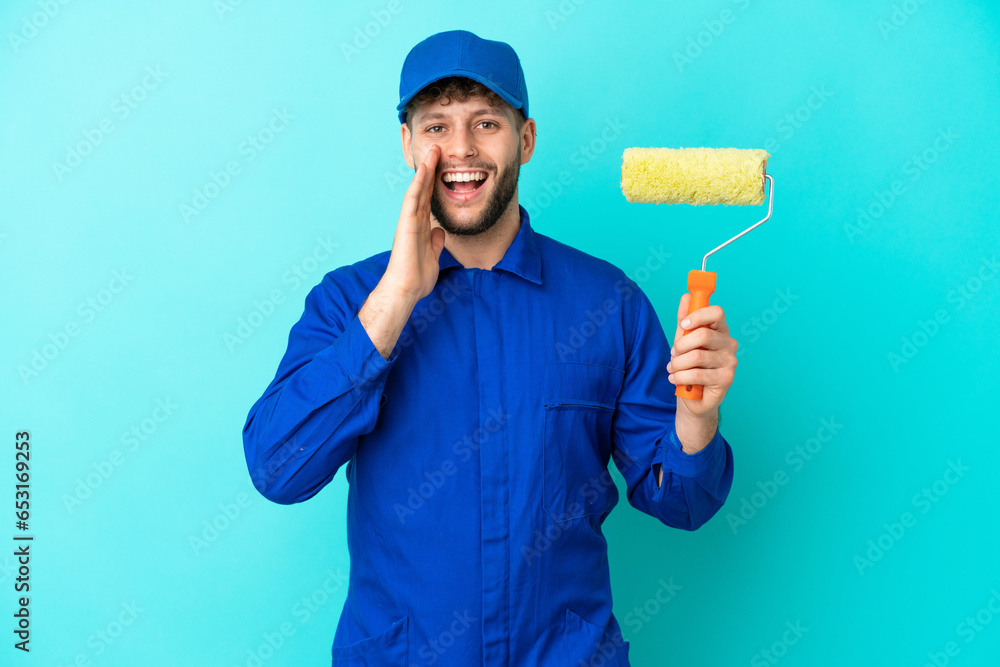 Painter caucasian man isolated on blue background shouting with mouth wide open