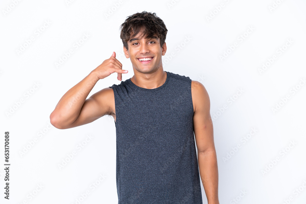Young sport caucasian man isolated on white background making phone gesture. Call me back sign Young sport caucasian man isolated on white background making phone gesture. Call me back sign